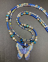 Load image into Gallery viewer, This Sterling Silver Dark Blue, Silver and Gold Butterfly Pendant is handcrafted from a basil leaf, and is meticulously painted in brilliant blues and silver. A range of multi-colored glass beads from deep blue to pale silver and gold tones combine to create a stunning lapis stone-like effect. This nature-inspired jewelry piece is perfect for adding a touch of summery style to any look.  Measurements:   Necklace is 15 1/2” adjustable up to 18"