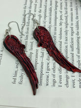 Load image into Gallery viewer, Red angel wings earrings made of polymer clay. These earrings are designed to face forward when worn instead of the front wings showing on the side.