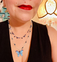 Load image into Gallery viewer, This Sterling Silver Bright Sky Blue and Silver Butterfly Pendant is detailed with a basil leaf motif. With vibrant hues of blue and silver, the pendant is complimented by multi-color glass beads to create the ideal summer jewelry piece.  Measurements:  Necklace is 16 1/2”adjustable up to 18"
