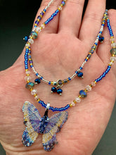 Load image into Gallery viewer, This Sterling Silver Dark Blue, Silver and Gold Butterfly Pendant is handcrafted from a basil leaf, and is meticulously painted in brilliant blues and silver. A range of multi-colored glass beads from deep blue to pale silver and gold tones combine to create a stunning lapis stone-like effect. This nature-inspired jewelry piece is perfect for adding a touch of summery style to any look.  Measurements:   Necklace is 15 1/2” adjustable up to 18"