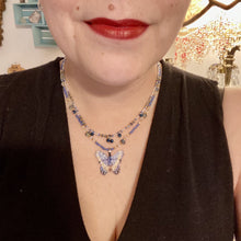 Load image into Gallery viewer, This Sterling Silver Dark Blue, Silver and Gold Butterfly Pendant is handcrafted from a basil leaf, and is meticulously painted in brilliant blues and silver. A range of multi-colored glass beads from deep blue to pale silver and gold tones combine to create a stunning lapis stone-like effect. This nature-inspired jewelry piece is perfect for adding a touch of summery style to any look.  Measurements:   Necklace is 15 1/2” adjustable up to 18"