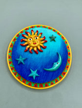 Load image into Gallery viewer, This handcrafted polymer clay wall art on a circle-shaped wood frame with a sun and crescent moon motifs on opposite side and stars. Its cool sky hues, including bright turquoise and dark royal blue, are further complemented by the bright orange and yellow frame adds an extra layer of sophistication to the warm-toned artwork. One of a kind art pieces come ready to hang with a sawtooth hangers in the back. Measurement 4" diameter.