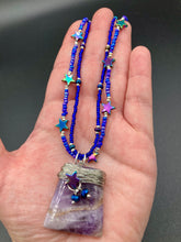 Load image into Gallery viewer, This elegant amethyst trapezoid pendant is artfully wirewrapped with a hematite star bead, making this a unique piece perfect for any occasion. Its two strands of colorful glass beads in a mix of cool blues, purples, and silver create an enchanting, starry night look sure to make a statement. Necklace is 16” in length and can be adjusted to 18"