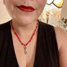 Load image into Gallery viewer, "Aphrodite" - the Ancient Greek goddess of love and beauty! Goddess pendant with a heart shaped feature represents love and beauty. The primary glass beads are of a vibrant red but every bead has a wide range of shimmers of gold and slightly different shades of red. Larger dark red glass beads stand out and give the necklace a different dimension and feel. Comes with matching rings and is the perfect pop of color to any outfit. Necklace is 17” adjustable to 19" - pendant is nickel free and 1 1/2”
