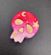 Load image into Gallery viewer, Inspired by nature, this skull statuette is full of vibrant colors and intricate details. The ombre colors from red, to light pink was inspired by the summer sky at sundown that I see all too often. I really wanted to capture those beautiful colors and added metallic gold moon and stars silhouettes to tie it all together.