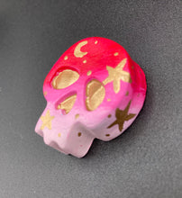 Load image into Gallery viewer, Inspired by nature, this skull statuette is full of vibrant colors and intricate details. The ombre colors from red, to light pink was inspired by the summer sky at sundown that I see all too often. I really wanted to capture those beautiful colors and added metallic gold moon and stars silhouettes to tie it all together.