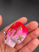 Load image into Gallery viewer, Inspired by nature, this skull statuette is full of vibrant colors and intricate details. The ombre colors from red, to light pink was inspired by the summer sky at sundown that I see all too often. I really wanted to capture those beautiful colors and added metallic gold moon and stars silhouettes to tie it all together.