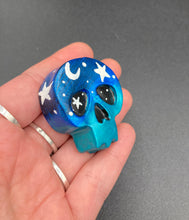 Load image into Gallery viewer, Ideal magnet design to adorn your refrigerator, lockers, workstation, toolbox, or dishwasher. This hand-sculpted clay skull statuette boasts stunning ombre coloration, transitioning from dark blue to light blue to recreate the breathtaking look of a starry night sky. H 1 1/2” x W 1 1/2” x D 3/4”