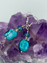 Load image into Gallery viewer, The Whimsical Teal Blue-Purple Glass Beaded Earrings feature a delightful mix of blues, purples, and hints of gold, along with varied sizes and shapes for an eye-catching textural look. The quartzite beads have a captivating swirl pattern, combining dark red and dark blue hues.  Measurements: 1 1/2 ” in length