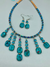 Load image into Gallery viewer, The Whimsical Teal Blue-Purple Glass Beaded Earrings feature a delightful mix of blues, purples, and hints of gold, along with varied sizes and shapes for an eye-catching textural look. The quartzite beads have a captivating swirl pattern, combining dark red and dark blue hues.  Measurements: 1 1/2 ” in length