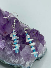 Load image into Gallery viewer, A single strand of white moonstone chip beads is accented with small light blue glass beads in these earrings, providing a nature-inspired look with a touch of bohemian vibes. Measurements: 1 1/2” in length