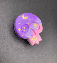 Load image into Gallery viewer, Perfect magnet design to adorn your refrigerator, lockers, workstation, toolbox, or dishwasher. This unique skull statuette features intricate details and vibrant colors, inspired by the summer sky at sundown. Variations in color from purple to light pink simulate the dramatic ombre seen in a setting sun, completed with golden stars and moon silhouettes for a celestial touch.   H 1 1/2” x W 1 1/2” x D 3/4”