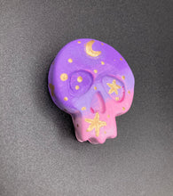 Load image into Gallery viewer, Perfect magnet design to adorn your refrigerator, lockers, workstation, toolbox, or dishwasher. This unique skull statuette features intricate details and vibrant colors, inspired by the summer sky at sundown. Variations in color from purple to light pink simulate the dramatic ombre seen in a setting sun, completed with golden stars and moon silhouettes for a celestial touch.   H 1 1/2” x W 1 1/2” x D 3/4”