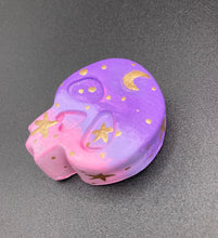 Load image into Gallery viewer, Perfect magnet design to adorn your refrigerator, lockers, workstation, toolbox, or dishwasher. This unique skull statuette features intricate details and vibrant colors, inspired by the summer sky at sundown. Variations in color from purple to light pink simulate the dramatic ombre seen in a setting sun, completed with golden stars and moon silhouettes for a celestial touch.   H 1 1/2” x W 1 1/2” x D 3/4”