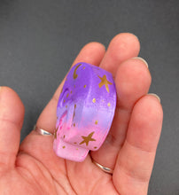 Load image into Gallery viewer, Perfect magnet design to adorn your refrigerator, lockers, workstation, toolbox, or dishwasher. This unique skull statuette features intricate details and vibrant colors, inspired by the summer sky at sundown. Variations in color from purple to light pink simulate the dramatic ombre seen in a setting sun, completed with golden stars and moon silhouettes for a celestial touch.   H 1 1/2” x W 1 1/2” x D 3/4”