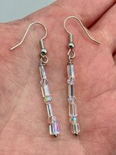 Load image into Gallery viewer, This pair of earrings features two strands of sparkling glass beads, in both rectangular and round shapes, with an iridescent sheen. Measurements: 1 3/16” in length