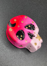 Load image into Gallery viewer, Ideal magnet design to adorn your refrigerator, lockers, workstation, toolbox, or dishwasher. This intricately detailed skull statuette is inspired by the beauty of nature, with vibrant colors ranging from red to a light pink reminiscent of a summer sky at dusk. A black moon and gold stars were added to provide a unified aesthetic. H 1 1/2” x W 1 1/2” x D 3/4”