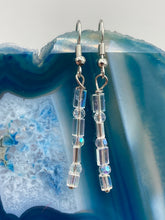 Load image into Gallery viewer, This pair of earrings features two strands of sparkling glass beads, in both rectangular and round shapes, with an iridescent sheen. Measurements: 1 3/16” in length