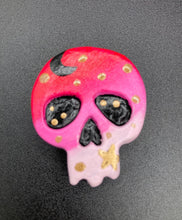 Load image into Gallery viewer, Ideal magnet design to adorn your refrigerator, lockers, workstation, toolbox, or dishwasher. This intricately detailed skull statuette is inspired by the beauty of nature, with vibrant colors ranging from red to a light pink reminiscent of a summer sky at dusk. A black moon and gold stars were added to provide a unified aesthetic. H 1 1/2” x W 1 1/2” x D 3/4”