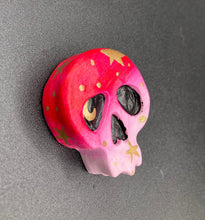 Load image into Gallery viewer, Cute and spooky magnet design to adorn your refrigerator, lockers, workstation, toolbox, or dishwasher. This statuette is exquisitely detailed and full of vivid colors, inspired by natural elements. The ombre effect from red to light pink replicates the hues of a summer sky at sundown, with added metallic gold moon and star silhouettes to complete the look. H 1 1/2” x W 1 1/2” x D 3/4”