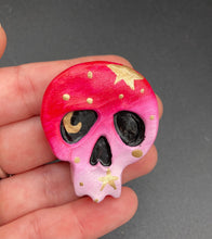 Load image into Gallery viewer, Cute and spooky magnet design to adorn your refrigerator, lockers, workstation, toolbox, or dishwasher. This statuette is exquisitely detailed and full of vivid colors, inspired by natural elements. The ombre effect from red to light pink replicates the hues of a summer sky at sundown, with added metallic gold moon and star silhouettes to complete the look. H 1 1/2” x W 1 1/2” x D 3/4”