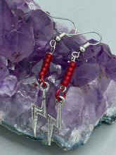 Load image into Gallery viewer, These Lightning Bolt Drop Earrings feature flat matte ruby-red glass beads and elegant lightning bolt charms. Measurements: 1 1/2” in length