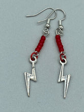Load image into Gallery viewer, These Lightning Bolt Drop Earrings feature flat matte ruby-red glass beads and elegant lightning bolt charms. Measurements: 1 1/2” in length