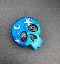 Load image into Gallery viewer, Cute and spooky magnet design to adorn your refrigerator, lockers, workstation, toolbox, or dishwasher. This hand-sculpted clay skull statuette boasts stunning ombre coloration, transitioning from dark blue to light blue to recreate the breathtaking look of a starry night sky. H 1 1/2” x W 1 1/2” x D 3/4”