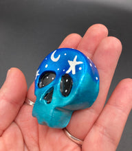 Load image into Gallery viewer, Cute and spooky magnet design to adorn your refrigerator, lockers, workstation, toolbox, or dishwasher. This hand-sculpted clay skull statuette boasts stunning ombre coloration, transitioning from dark blue to light blue to recreate the breathtaking look of a starry night sky. H 1 1/2” x W 1 1/2” x D 3/4”