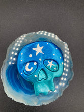 Load image into Gallery viewer, Ideal magnet design to adorn your refrigerator, lockers, workstation, toolbox, or dishwasher. This hand-sculpted clay skull statuette boasts stunning ombre coloration, transitioning from dark blue to light blue to recreate the breathtaking look of a starry night sky. H 1 1/2” x W 1 1/2” x D 3/4”