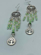 Load image into Gallery viewer, Be mesmerized by these large cascade style earrings, featuring five delicate strands of light green, iridescent and gold-tone beads with a tree of life charm for an eye-catching effect. Perfect for whimsical, nature-inspired looks, these earrings will liven up any outfit. Measurements: 3 3/4” in length