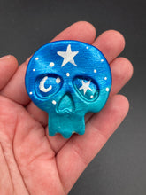 Load image into Gallery viewer, Ideal magnet design to adorn your refrigerator, lockers, workstation, toolbox, or dishwasher. This hand-sculpted clay skull statuette boasts stunning ombre coloration, transitioning from dark blue to light blue to recreate the breathtaking look of a starry night sky. H 1 1/2” x W 1 1/2” x D 3/4”