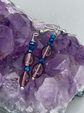 Load image into Gallery viewer, These dainty earrings feature a combination of light purple and dark blue glass beading for a sophisticated, versatile look. Perfect for a chic aesthetic, these earrings can easily complement any outfit.  Measurements: 1 3/8” in length
