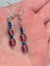 Load image into Gallery viewer, These dainty earrings feature a combination of light purple and dark blue glass beading for a sophisticated, versatile look. Perfect for a chic aesthetic, these earrings can easily complement any outfit.  Measurements: 1 3/8” in length