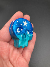 Load image into Gallery viewer, Ideal magnet design to adorn your refrigerator, lockers, workstation, toolbox, or dishwasher. This hand-sculpted clay skull statuette boasts stunning ombre coloration, transitioning from dark blue to light blue to recreate the breathtaking look of a starry night sky. H 1 1/2” x W 1 1/2” x D 3/4”