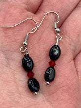 Load image into Gallery viewer, These delicate earrings feature beading of both black and dark red glass, perfectly harmonizing to make them a versatile accessory fit for a variety of looks, such as good witch, goth, and chic.  Measurements: 1 1/4” in length