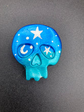 Load image into Gallery viewer, Ideal magnet design to adorn your refrigerator, lockers, workstation, toolbox, or dishwasher. This hand-sculpted clay skull statuette boasts stunning ombre coloration, transitioning from dark blue to light blue to recreate the breathtaking look of a starry night sky. H 1 1/2” x W 1 1/2” x D 3/4”