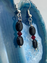 Load image into Gallery viewer, These delicate earrings feature beading of both black and dark red glass, perfectly harmonizing to make them a versatile accessory fit for a variety of looks, such as good witch, goth, and chic.  Measurements: 1 1/4” in length