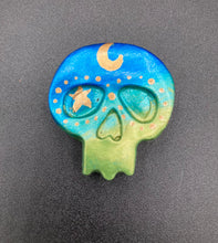 Load image into Gallery viewer, Inspired by nature, this skull statuette is full of vibrant colors and intricate details. The ombre colors from red, to light pink was inspired by the summer sky at sundown that I see all too often. I really wanted to capture those beautiful colors and added metallic gold moon and stars silhouettes to tie it all together.