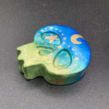 Load image into Gallery viewer, Inspired by nature, this skull statuette is full of vibrant colors and intricate details. The ombre colors from red, to light pink was inspired by the summer sky at sundown that I see all too often. I really wanted to capture those beautiful colors and added metallic gold moon and stars silhouettes to tie it all together.