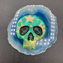 Load image into Gallery viewer, Ideal magnet design to adorn your refrigerator, lockers, workstation, toolbox, or dishwasher. Featuring intricate details and vibrant colors, this hand-painted skull statuette is inspired by nature. Its warm metallic green and gold hues recall the gorgeous tansy beetle, and the addition of moon and stars silhouettes creates a complete celestial motif.  H 1 1/2” x W 1 1/2” x D 3/4”