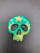 Load image into Gallery viewer, Ideal magnet design to adorn your refrigerator, lockers, workstation, toolbox, or dishwasher. Featuring intricate details and vibrant colors, this hand-painted skull statuette is inspired by nature. Its warm metallic green and gold hues recall the gorgeous tansy beetle, and the addition of moon and stars silhouettes creates a complete celestial motif.  H 1 1/2” x W 1 1/2” x D 3/4”