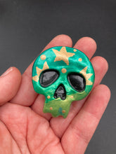 Load image into Gallery viewer, Ideal magnet design to adorn your refrigerator, lockers, workstation, toolbox, or dishwasher. Featuring intricate details and vibrant colors, this hand-painted skull statuette is inspired by nature. Its warm metallic green and gold hues recall the gorgeous tansy beetle, and the addition of moon and stars silhouettes creates a complete celestial motif.  H 1 1/2” x W 1 1/2” x D 3/4”