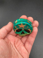 Load image into Gallery viewer, Ideal magnet design to adorn your refrigerator, lockers, workstation, toolbox, or dishwasher. Featuring intricate details and vibrant colors, this hand-painted skull statuette is inspired by nature. Its warm metallic green and gold hues recall the gorgeous tansy beetle, and the addition of moon and stars silhouettes creates a complete celestial motif.  H 1 1/2” x W 1 1/2” x D 3/4”