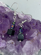 Load image into Gallery viewer, This unique set of earrings features large, square-shaped black obsidian beads accented by small, square hematite beads with flat disk details. It offers a versatile style perfect for any occasion. Measurements: 1” in length