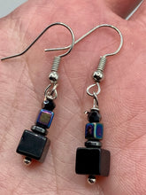 Load image into Gallery viewer, This unique set of earrings features large, square-shaped black obsidian beads accented by small, square hematite beads with flat disk details. It offers a versatile style perfect for any occasion. Measurements: 1” in length