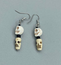 Load image into Gallery viewer, This mini howlite and bone skull bead set of earrings offers a unique touch to any goth, emo, witchy, or Day of the Dead ensemble. The black glass bead accents bring a sophisticated note to the look, and the earrings can easily be dressed up or down. Measurements: 1 1/4 ” in length
