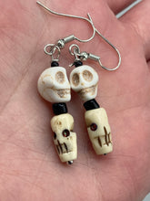 Load image into Gallery viewer, This mini howlite and bone skull bead set of earrings offers a unique touch to any goth, emo, witchy, or Day of the Dead ensemble. The black glass bead accents bring a sophisticated note to the look, and the earrings can easily be dressed up or down. Measurements: 1 1/4 ” in length