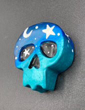 Load image into Gallery viewer, Ideal magnet design to adorn your refrigerator, lockers, workstation, toolbox, or dishwasher. This hand-sculpted clay skull statuette boasts stunning ombre coloration, transitioning from dark blue to light blue to recreate the breathtaking look of a starry night sky. H 1 1/2” x W 1 1/2” x D 3/4”