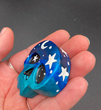 Load image into Gallery viewer, Ideal magnet design to adorn your refrigerator, lockers, workstation, toolbox, or dishwasher. This hand-sculpted clay skull statuette boasts stunning ombre coloration, transitioning from dark blue to light blue to recreate the breathtaking look of a starry night sky. H 1 1/2” x W 1 1/2” x D 3/4”